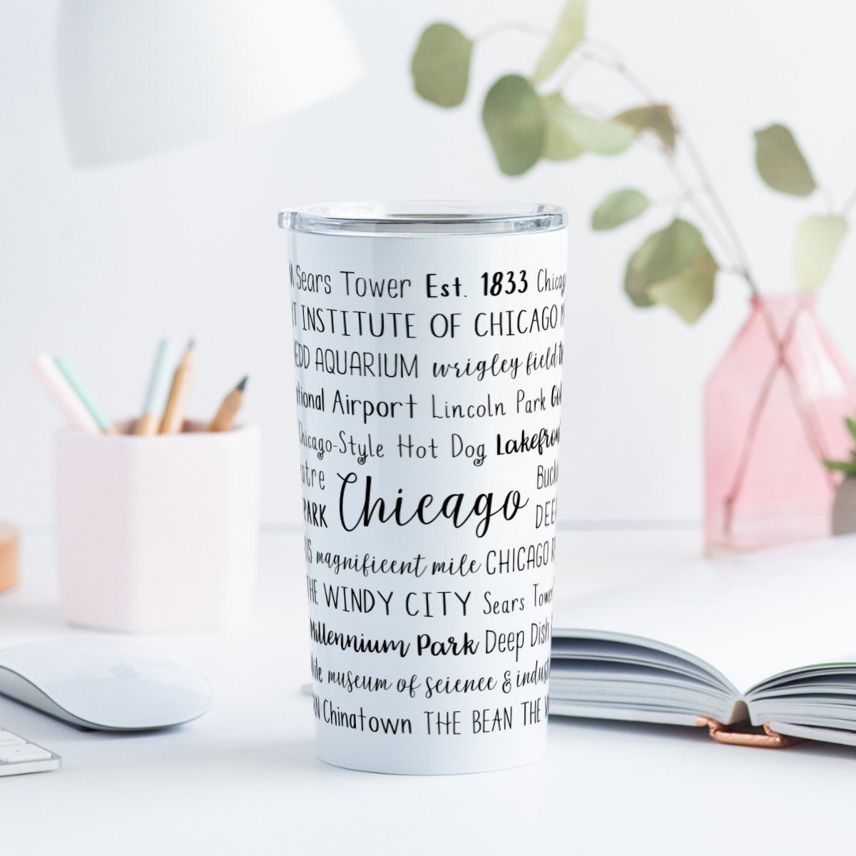 A perfect Valentine's Day gift for travel lovers is this unique travel mug with a city in the middle and surrounded by words about it.